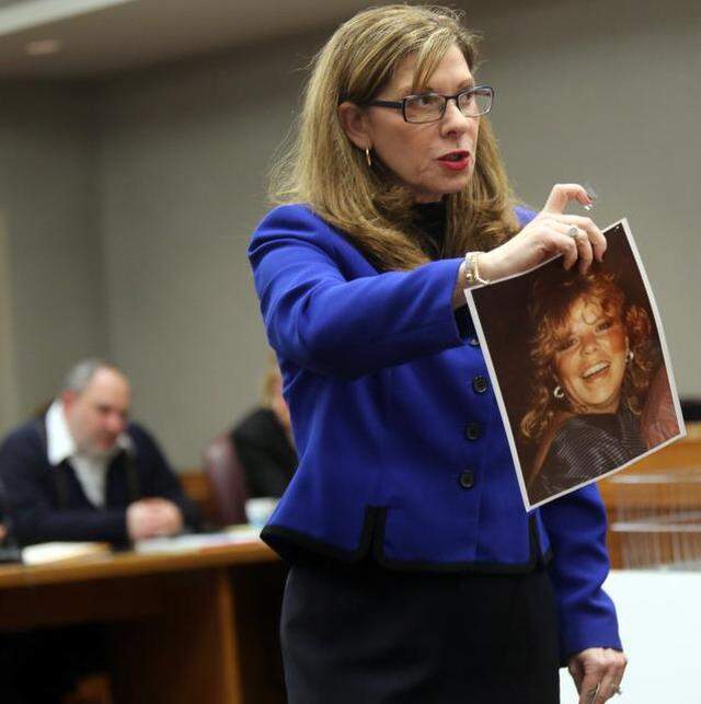 Prosecutor, Gail Levine, holds up a photo of murder victim Linda Azcarreta, 32, stabbed to death by Rafael Andres (pictured in the background) in 1987. Andres later went on to murder Yvette Fariñas in 2005.